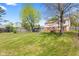 Spacious backyard with a grassy lawn, a deck, and a fire pit at 4322 Matrea More Ct, Indianapolis, IN 46254