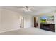 Bedroom with carpeted floors, ceiling fan and television with fireplace stand at 4322 Matrea More Ct, Indianapolis, IN 46254