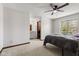 Bright bedroom featuring a ceiling fan, window, and ensuite bathroom with a vanity at 4322 Matrea More Ct, Indianapolis, IN 46254