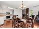 A dining room is adjacent to the kitchen with white appliances and cabinets at 4322 Matrea More Ct, Indianapolis, IN 46254