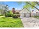 Charming home with a two-car garage and well-maintained front yard and brick chimney at 4322 Matrea More Ct, Indianapolis, IN 46254