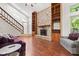 Detailed stone fireplace with built-in shelves and hardwood flooring at 4322 Matrea More Ct, Indianapolis, IN 46254