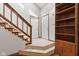 Bright foyer with tiled flooring, stairs, and a built-in bookcase at 4322 Matrea More Ct, Indianapolis, IN 46254