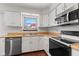 Kitchen with stainless steel appliances, light wood counters, and white cabinets at 4322 Matrea More Ct, Indianapolis, IN 46254