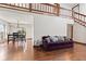 Bright living room featuring hardwood floors, a staircase and a purple sofa at 4322 Matrea More Ct, Indianapolis, IN 46254