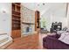 Cozy living area featuring a stone fireplace, hardwood floors, and built-in bookshelves at 4322 Matrea More Ct, Indianapolis, IN 46254