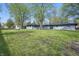 Large backyard with mature trees and view of grey painted home at 4450 Bridgefield West Dr, Plainfield, IN 46168