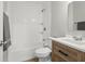 Updated bathroom featuring a vanity with wood finish, bathtub with tile surround, and modern fixtures at 4450 Bridgefield West Dr, Plainfield, IN 46168