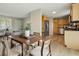 Open-concept dining area featuring a wooden table, seating for four, and a seamless transition to the kitchen at 4450 Bridgefield West Dr, Plainfield, IN 46168