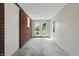 Hallway featuring a brick wall, white walls, and double doors leading to the backyard at 4450 Bridgefield West Dr, Plainfield, IN 46168