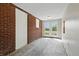 Hallway with brick accent wall leading to double doors and backyard view at 4450 Bridgefield West Dr, Plainfield, IN 46168