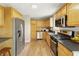 Well-lit kitchen boasting wooden cabinets, stainless steel appliances, and sleek countertops at 4450 Bridgefield West Dr, Plainfield, IN 46168