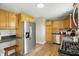 Spacious kitchen with stainless steel appliances, wooden cabinetry, and modern countertops at 4450 Bridgefield West Dr, Plainfield, IN 46168