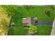 An aerial view of a home with a fenced backyard, a small storage shed and lush green grass at 4525 Shelbyville Rd, Indianapolis, IN 46237