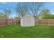 Backyard featuring green grass, a wooden fence, and a shed at 4525 Shelbyville Rd, Indianapolis, IN 46237
