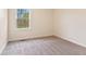 This bedroom features neutral walls, carpet, and a window at 4525 Shelbyville Rd, Indianapolis, IN 46237