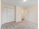 This bedroom features neutral carpet, and a double door closet at 4525 Shelbyville Rd, Indianapolis, IN 46237
