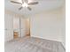 Spacious bedroom with plush carpeting, neutral walls and an attached bathroom at 4525 Shelbyville Rd, Indianapolis, IN 46237