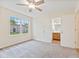 Bright bedroom with soft carpet, neutral walls, and an attached bathroom at 4525 Shelbyville Rd, Indianapolis, IN 46237