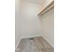 This closet features neutral carpeting and a built-in shelf with a rod at 4525 Shelbyville Rd, Indianapolis, IN 46237