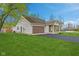Attractive home with a well-manicured front lawn, driveway, and an attached garage at 4525 Shelbyville Rd, Indianapolis, IN 46237
