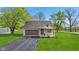 Charming home with a well-maintained front yard, a driveway, and a brown garage door at 4525 Shelbyville Rd, Indianapolis, IN 46237