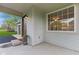 A close-up of the front porch with the front door, a welcome mat and a large window on the side at 4525 Shelbyville Rd, Indianapolis, IN 46237