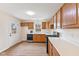Functional kitchen with wood cabinets, modern appliances, and ample counter space for food preparation at 4525 Shelbyville Rd, Indianapolis, IN 46237