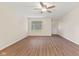 The living room showcases wood flooring, a ceiling fan and a front entrance with a window at 4525 Shelbyville Rd, Indianapolis, IN 46237