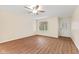 Living room showcasing hardwood floors, a ceiling fan, a front door, and a bright window at 4525 Shelbyville Rd, Indianapolis, IN 46237