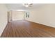 Spacious living room with wood floors, a ceiling fan and a window bringing in natural light at 4525 Shelbyville Rd, Indianapolis, IN 46237