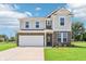 Inviting two-story home featuring a brick and siding facade, well-manicured lawn, and an attached two-car garage at 4718 E Shadowbrook Dr, Camby, IN 46113