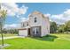 Elegant two-story home showcasing brick and siding, a two-car garage, and lush green lawn on a sunny day at 4718 E Shadowbrook Dr, Camby, IN 46113