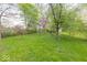 Expansive backyard with lush grass and trees, offering a serene outdoor space at 476 Southgate Dr, Greenwood, IN 46143