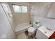Compact bathroom featuring a standard tub, toilet, vanity, and window for natural light at 476 Southgate Dr, Greenwood, IN 46143