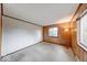 Cozy bedroom with mixed wood paneling and white walls, illuminated by natural light at 476 Southgate Dr, Greenwood, IN 46143
