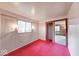 Bedroom showcasing red carpet, closet and a window with natural light at 476 Southgate Dr, Greenwood, IN 46143