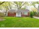 Charming brick home with a well-manicured lawn and mature trees in a peaceful neighborhood at 476 Southgate Dr, Greenwood, IN 46143