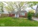Inviting brick home featuring a well-maintained lawn, classic design, and beautiful mature trees at 476 Southgate Dr, Greenwood, IN 46143