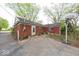 Back exterior of a brick home, with a basketball hoop, and a small yard at 476 Southgate Dr, Greenwood, IN 46143