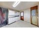 A kitchen with white cabinets, essential appliances, and a convenient laundry area at 476 Southgate Dr, Greenwood, IN 46143