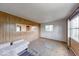 Spacious living room with wood paneled walls, large windows, and carpeted floors at 476 Southgate Dr, Greenwood, IN 46143