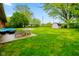 Lush backyard featuring a patio seating area, shed, and ample green space for outdoor enjoyment at 507 S Grant St, Brownsburg, IN 46112