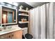 Contemporary bathroom with a dark accent wall featuring floating shelves, ample light, and a modern shower at 507 S Grant St, Brownsburg, IN 46112