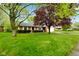 Charming brick home with lush front lawn and mature trees creating a picturesque setting at 507 S Grant St, Brownsburg, IN 46112