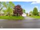 Classic brick home with attached garage, set on a green lawn with mature trees on a clear day at 507 S Grant St, Brownsburg, IN 46112