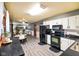 This kitchen offers white cabinets, black appliances, and opens into the living area at 507 S Grant St, Brownsburg, IN 46112