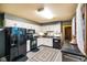 Open-concept kitchen featuring white cabinets, modern appliances, and plenty of natural light at 507 S Grant St, Brownsburg, IN 46112