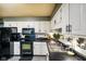 The kitchen is equipped with sleek black appliances, ample counter space, and white cabinetry at 507 S Grant St, Brownsburg, IN 46112