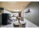 Bright eat-in kitchen boasts white cabinetry, modern black appliances, and gray accent walls at 507 S Grant St, Brownsburg, IN 46112